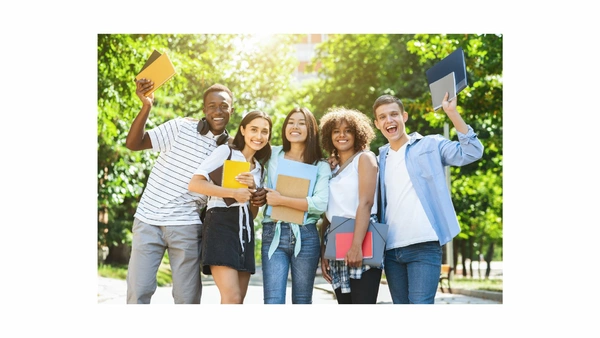 Group of diverse students smiling while holding books outdoors, showcasing enthusiasm for learning and friendship. Group of diverse students smiling while holding books outdoors, showcasing enthusiasm for learning and friendship.
